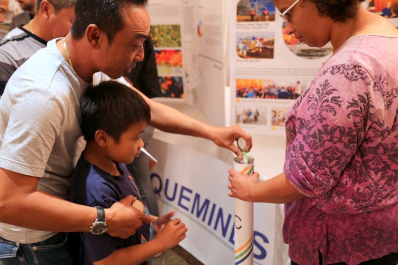 A man and young boy participate in an exercise with at an LA SAFE planning meeting